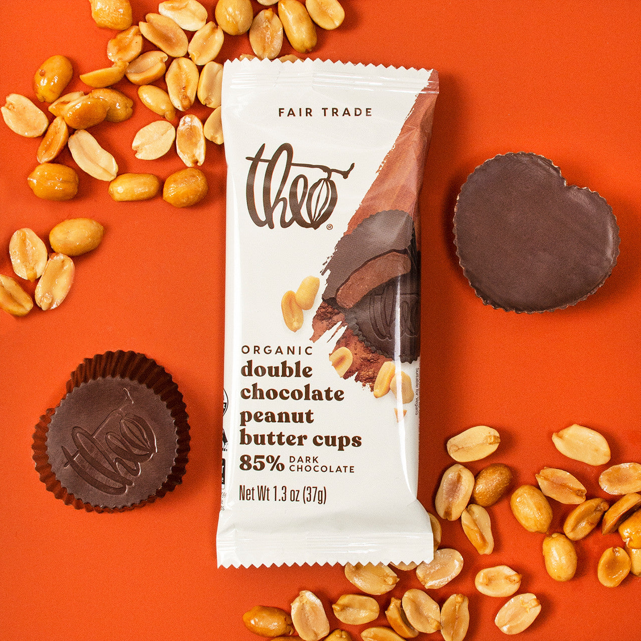 Theo organic double chocolate peanut butter cups packaging with heart shaped chocolate cups and peanuts on an orange background