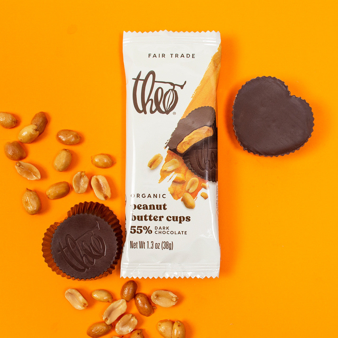 Theo Organic Peanut Butter Cups packaging with heart shaped chocolate cups and peanuts on an orange background