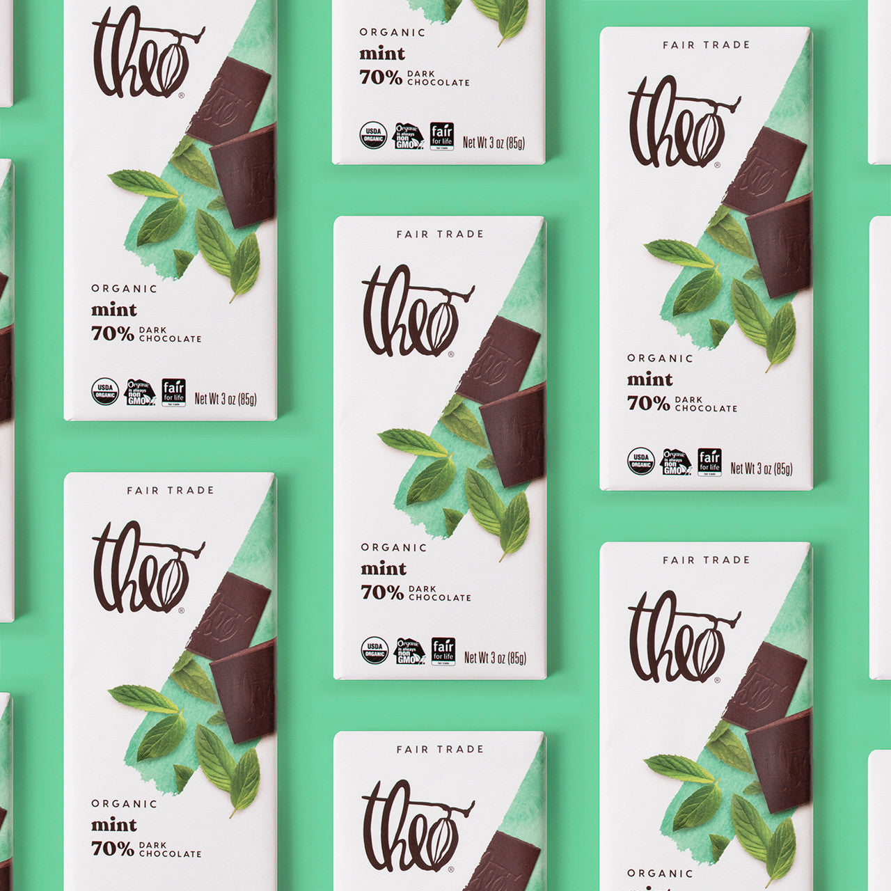 Multiple bars of Theo Organic Mint 70% Dark Chocolate on a green background
