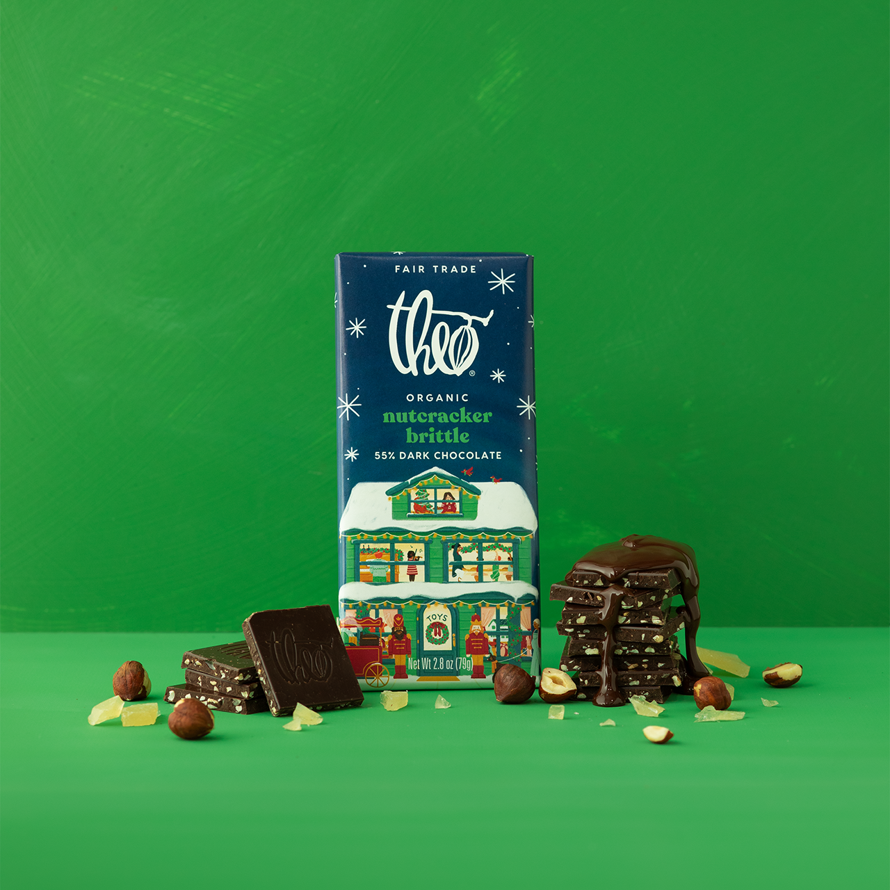 Theo nutcracker brittle dark chocolate bar packaging with chocolate pieces and nuts on a green background