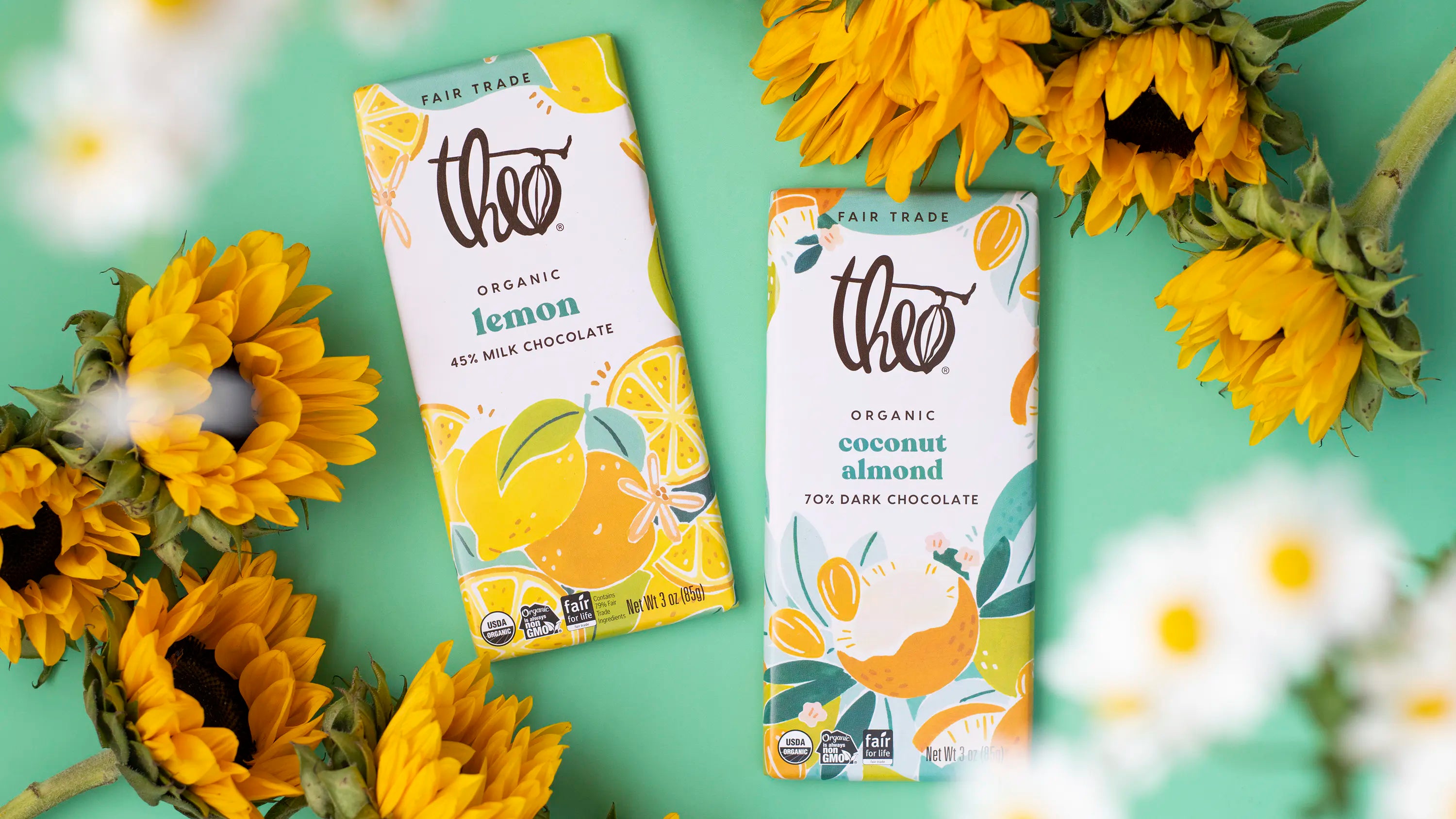 Two Theo chocolate bars, one lemon and one coconut almond, surrounded by sunflowers on a green background.