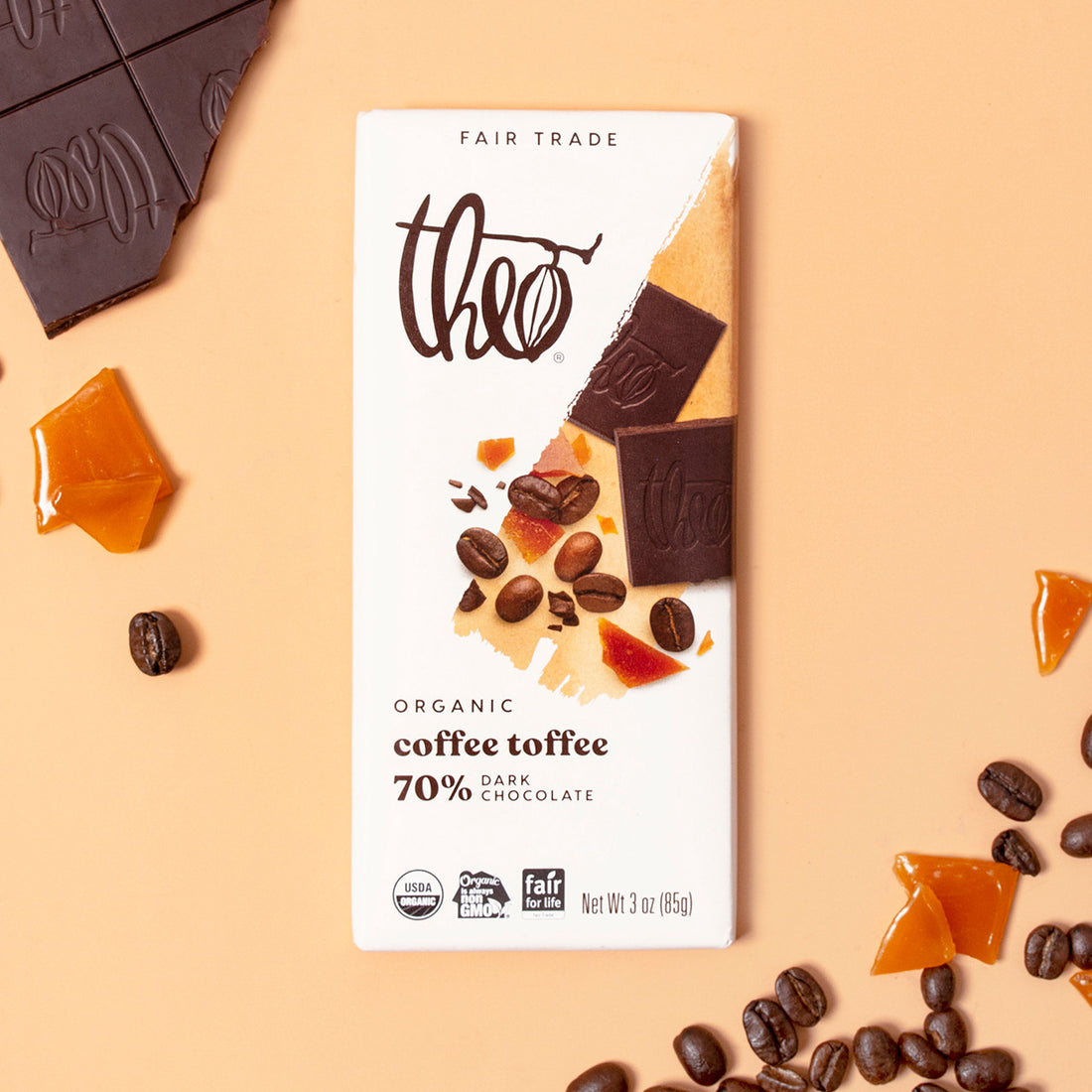 Theo Organic Coffee Toffee chocolate bar with ingredients on a beige background