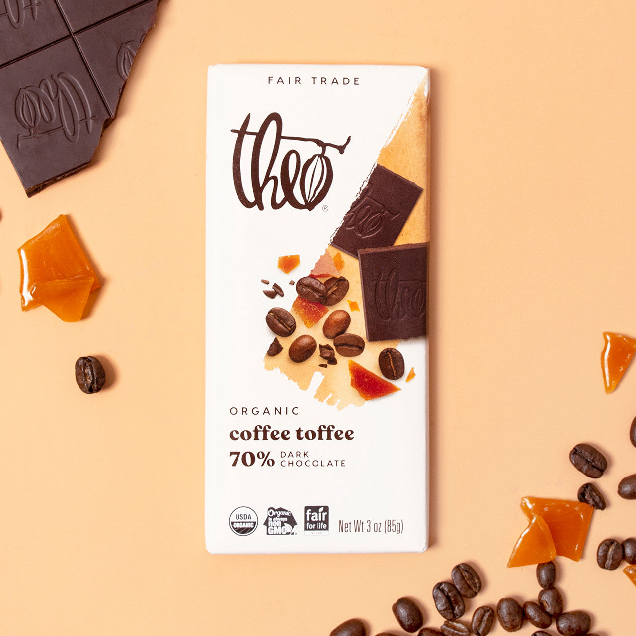 Theo Organic Coffee Toffee chocolate bar with ingredients on a beige background