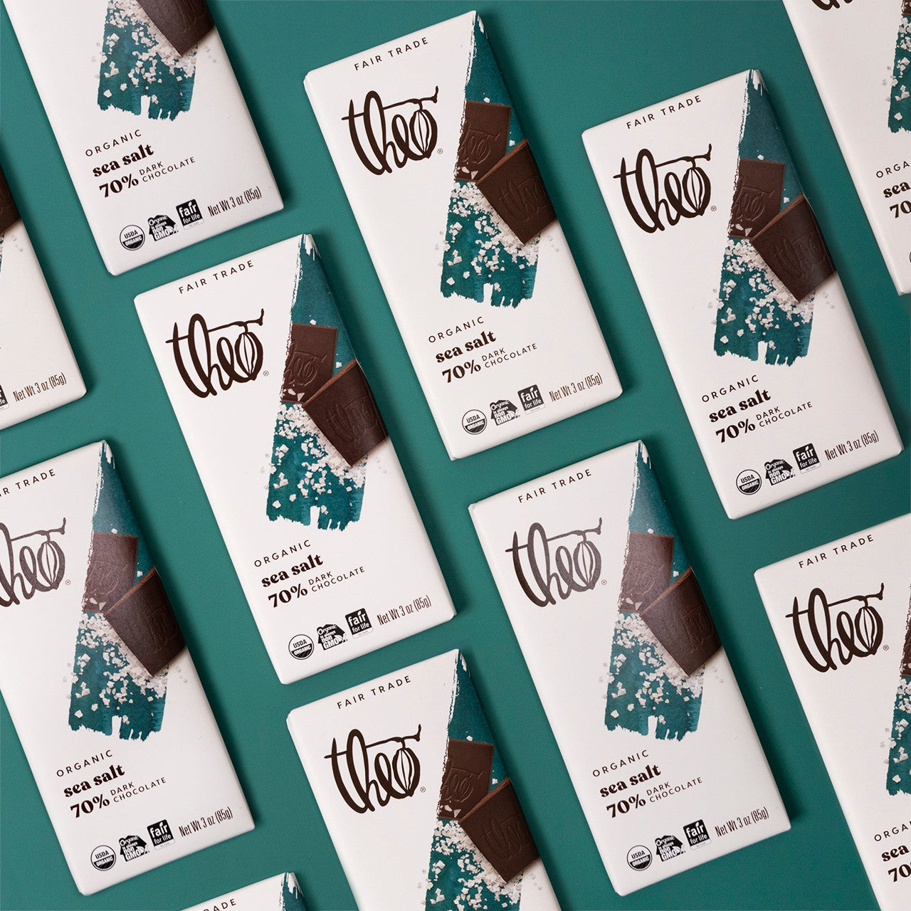 Multiple Theo Organic Sea Salt 70% chocolate bars on a teal background