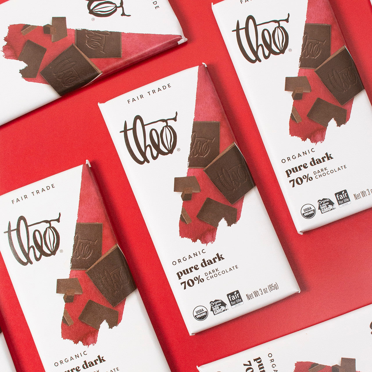 Theo Organic pure dark chocolate bars on a red background