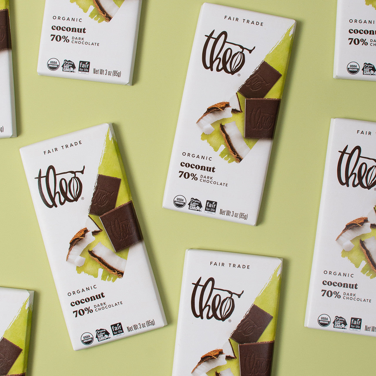 Multiple boxes of Theo Organic Coconut 70% Dark Chocolate on a light green background