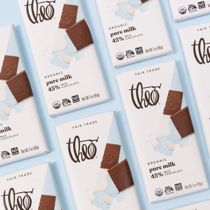 Multiple Theo milk chocolate bars and packaging on a light blue background