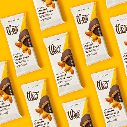 Pattern of Theo Organic Almond Butter Cups packaging on a yellow background