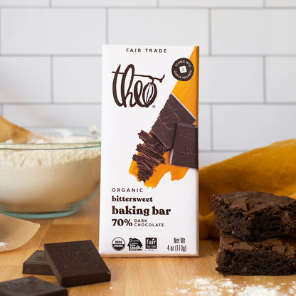 Theo Organic Bittersweet Baking Bar on a kitchen counter with brownies and flour.