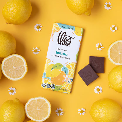 Theo organic lemon milk chocolate bar surrounded by lemons on a yellow background