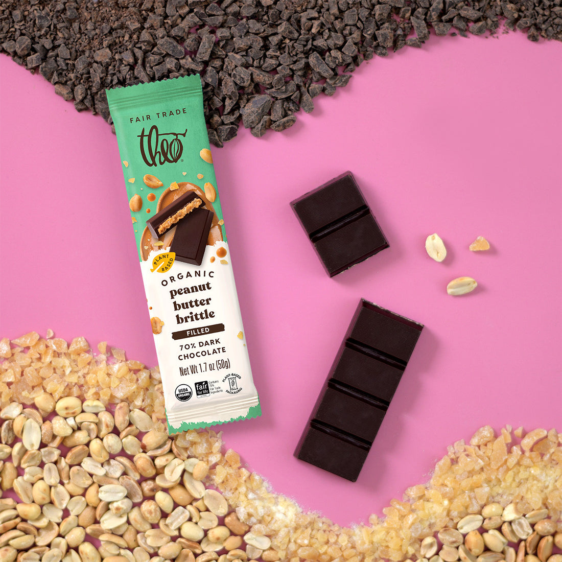Treo organic peanut butter brittle bar with dark chocolate pieces and peanuts on a pink background