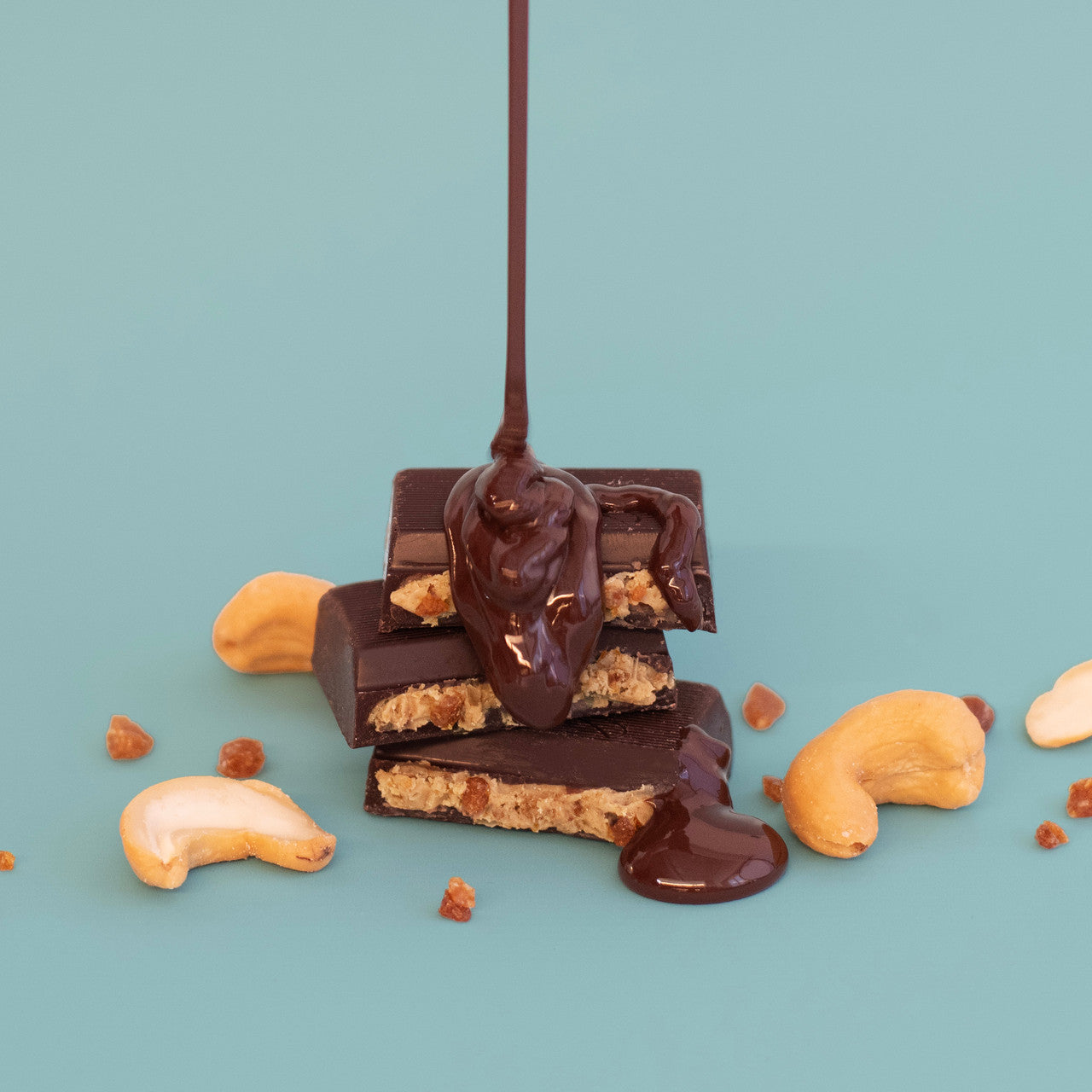 Chocolate bars with cashews on a light blue background