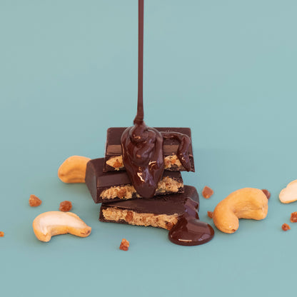 Chocolate bars with cashews on a light blue background