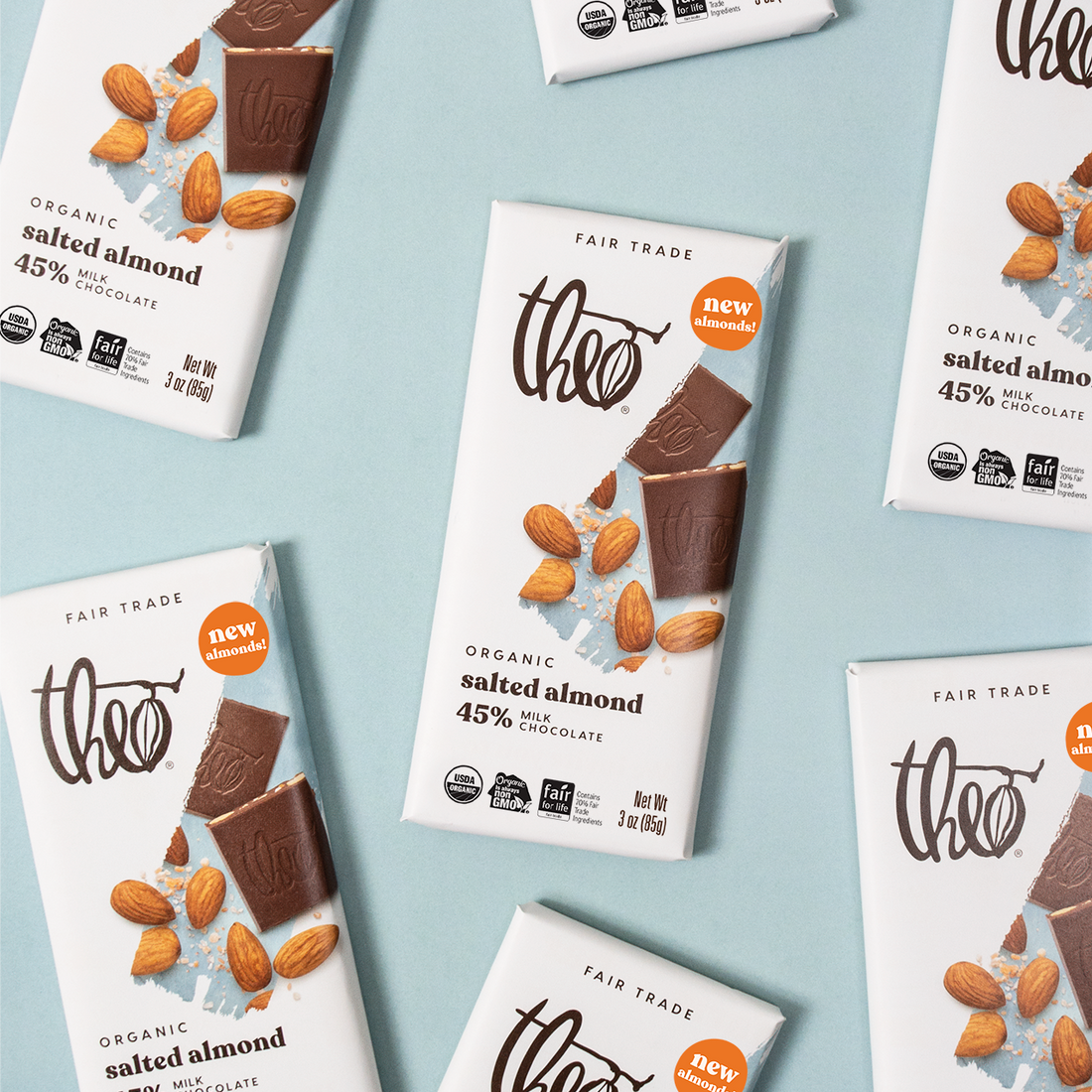 Multiple Theo Organic salted almond chocolate bars on a light blue background