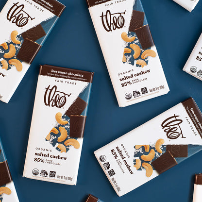 Theo dark chocolate bars with cashew pieces on a blue background
