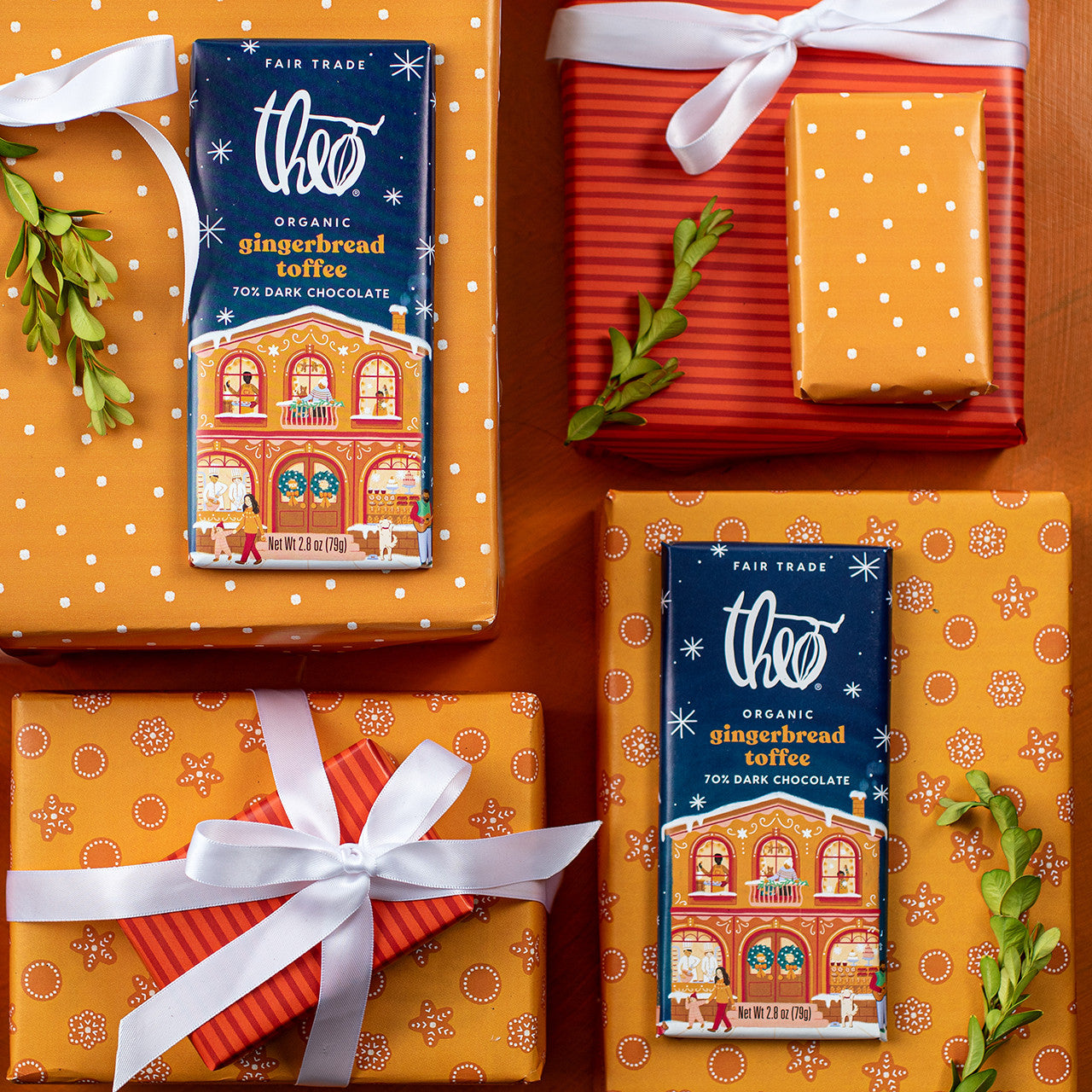 Theo Organic Gingerbread Toffee dark chocolate bars on orange gift boxes with white ribbons.