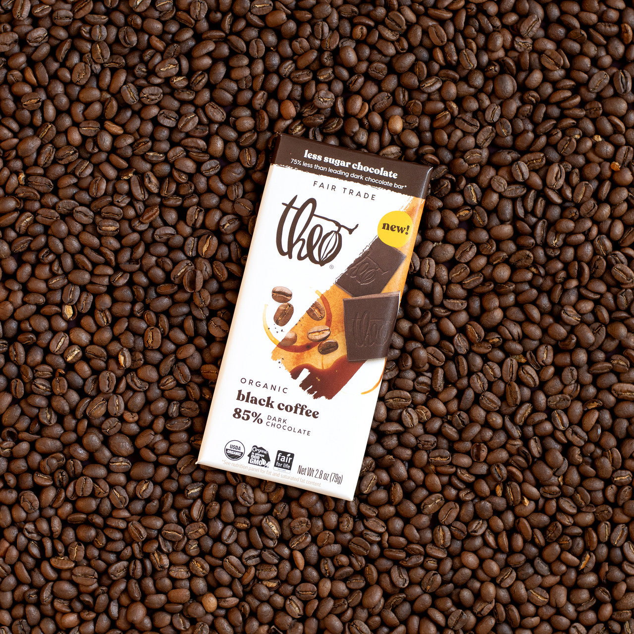 Theo organic black coffee 85% dark chocolate bar on a bed of coffee beans