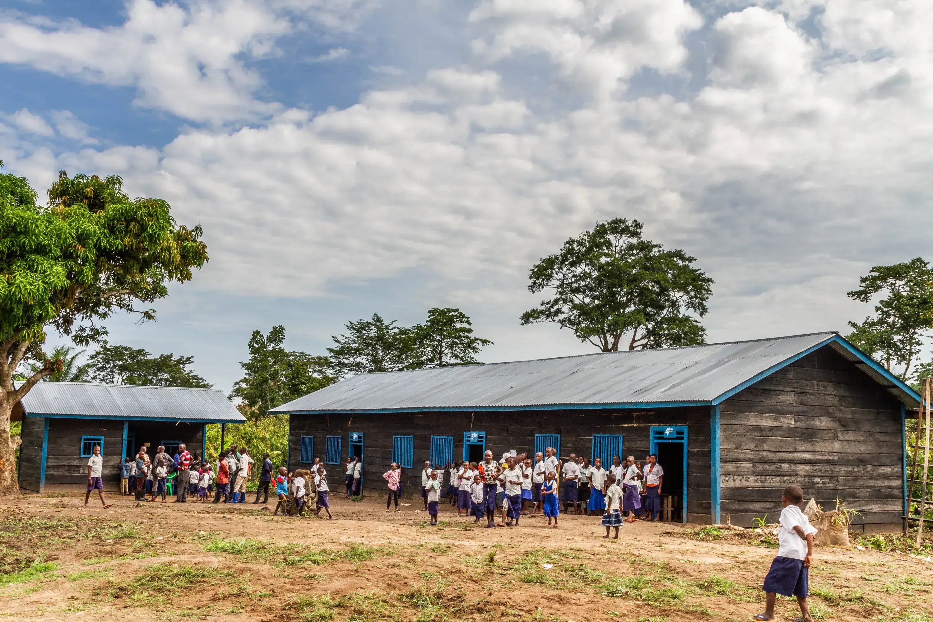 School building with children outside on a sunny day
